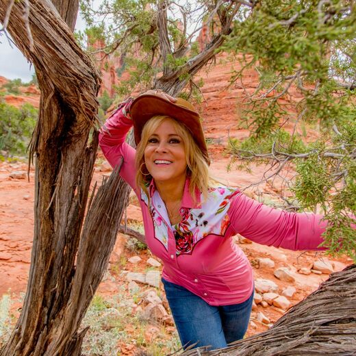 Photo of Rosane looking through a tree in sedona
