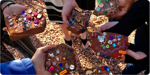 A group of people holding chocolate bars covered in candy.