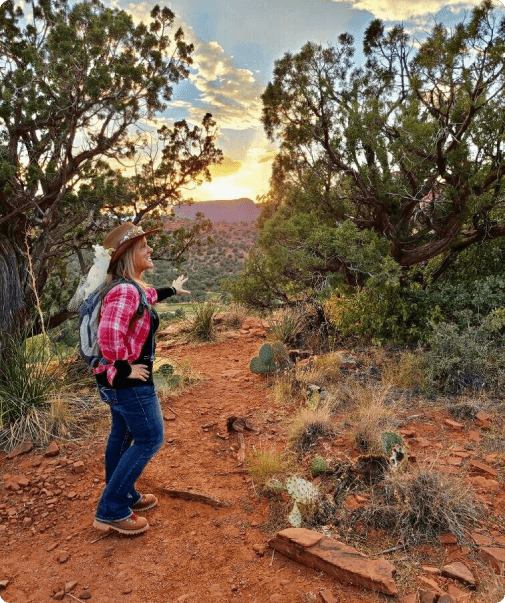 A woman with a backpack walking on the trail